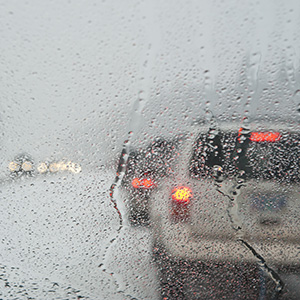 Winter traffic jam seen through a wet windshield