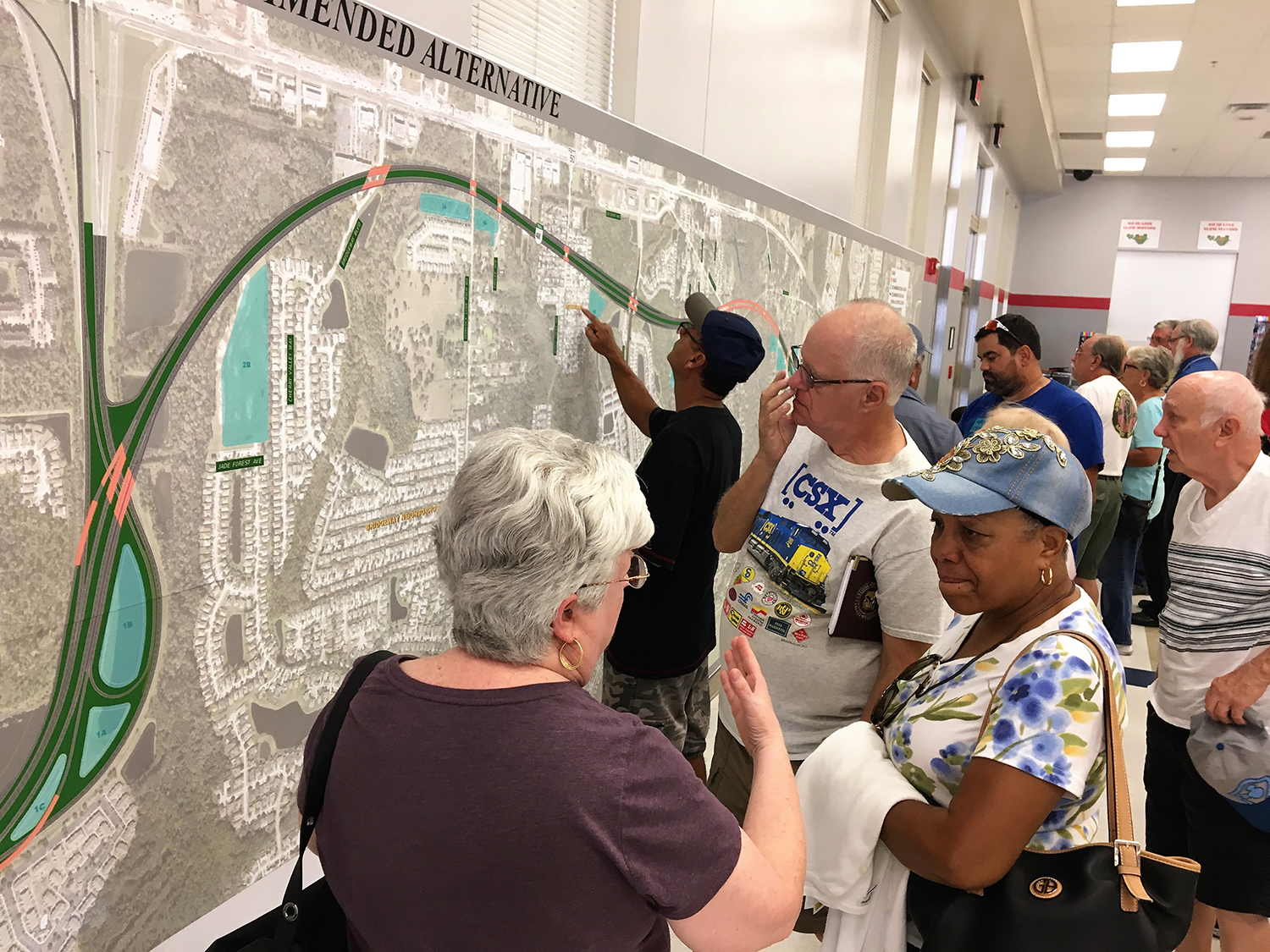 Citizens study maps of the PD&E Study for State Road 408 Eastern Extension during a public meeting