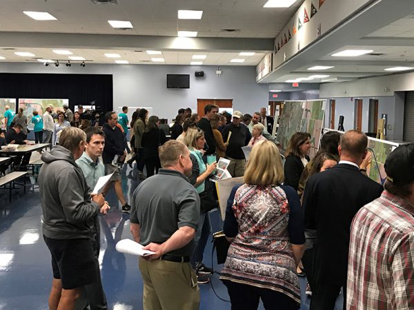 Citizens examine maps at Osceola Parkway Extension Public Meeting