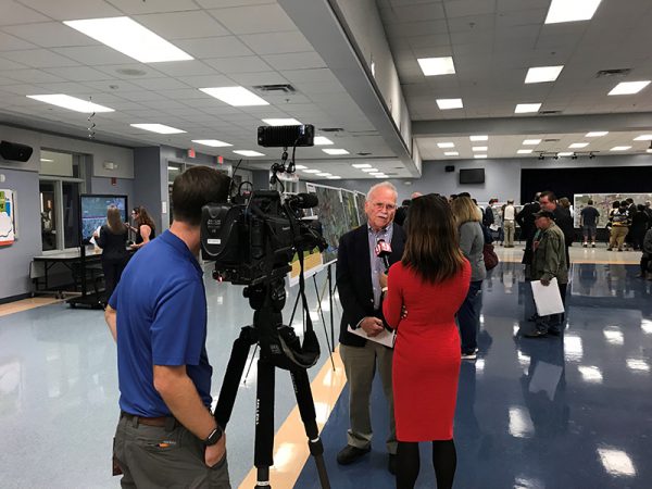 Local news crew interviews citizens at Osceola Parkway Extension Public Meeting