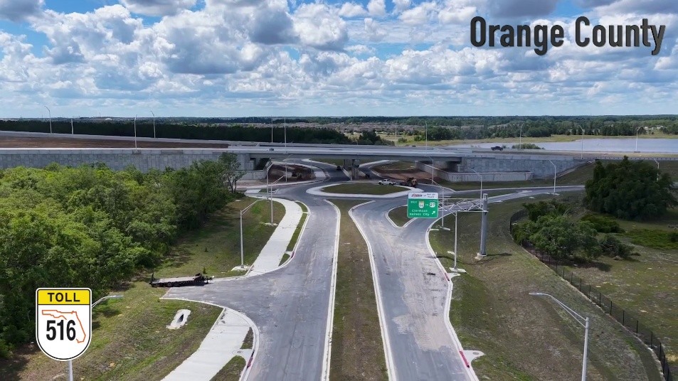 SR 516 at Valencia Pkwy Aerial view of a toll road interchange in Orange County with multiple curved ramps and an overpass, green landscape nearby.